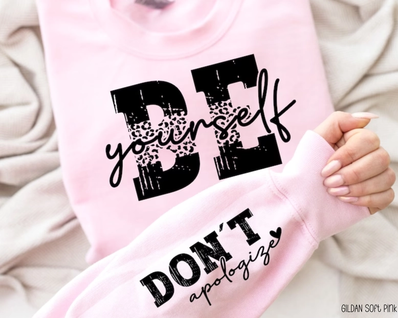 Blush pink Be Yourself Don't Apologize sweatshirt with leopard print graphic and sleeve detail